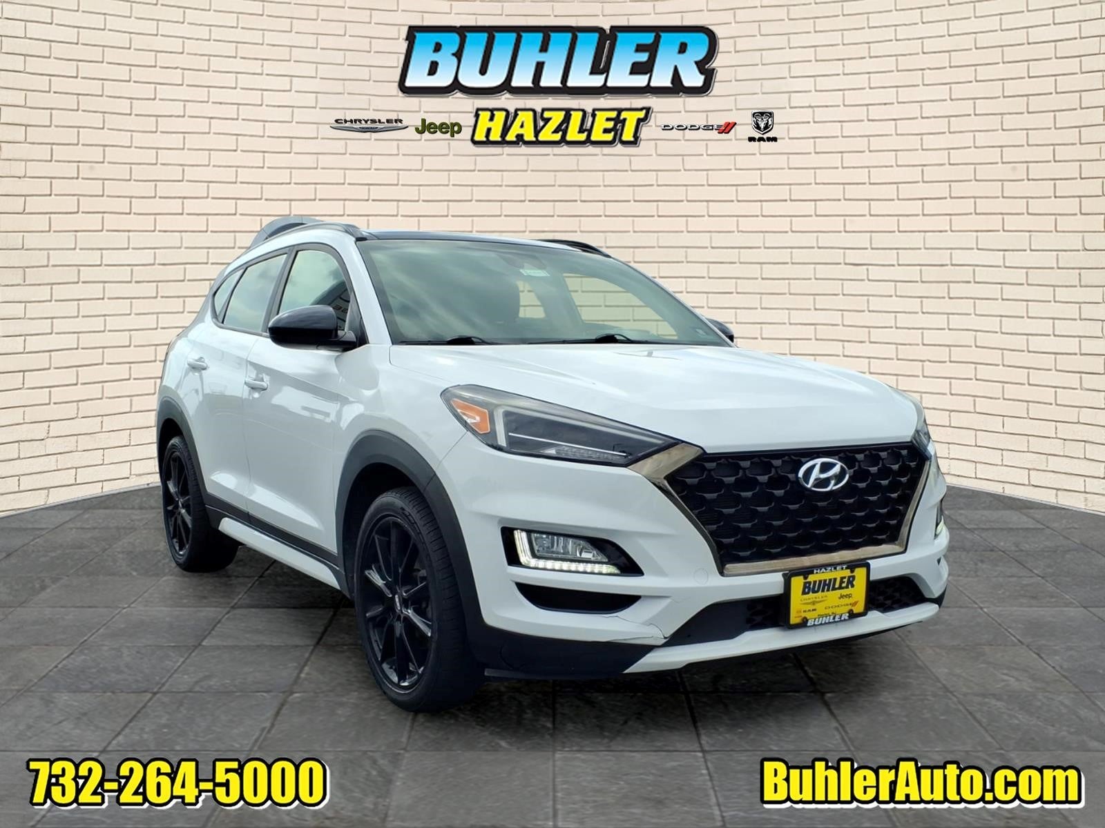 2019 Hyundai Tucson Night in Dazzling White — front three-quarter view